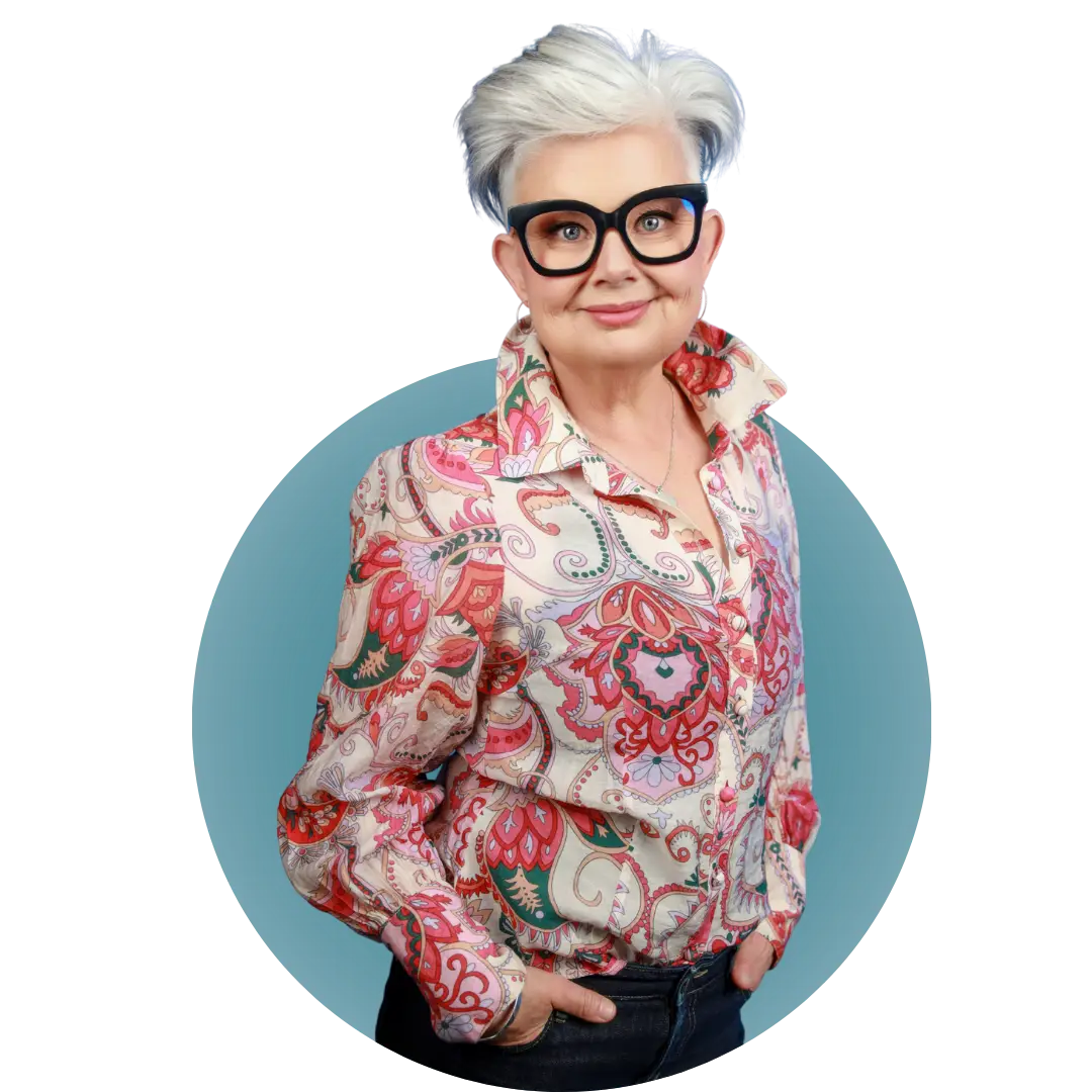 Mish Wright, fitness and women's health educator, standing smiling in a patterned blouse